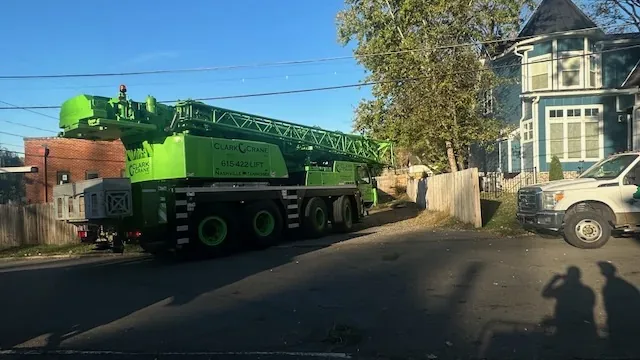 Crane staged on a residential street for a technical tree removal