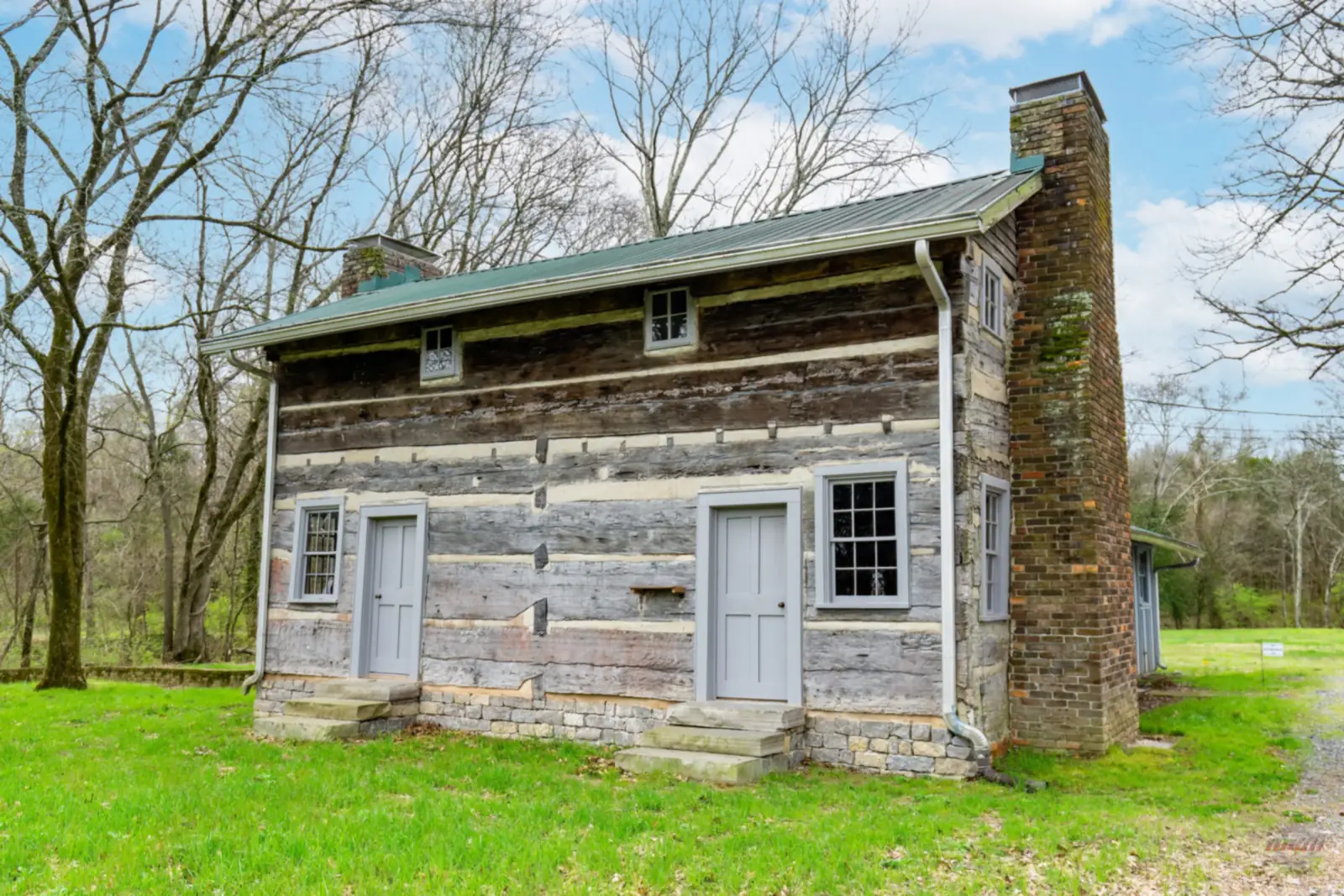 The Bridal House, an 1819 two-story log cabin with a stone chimney, in Cottontown, Tennessee
