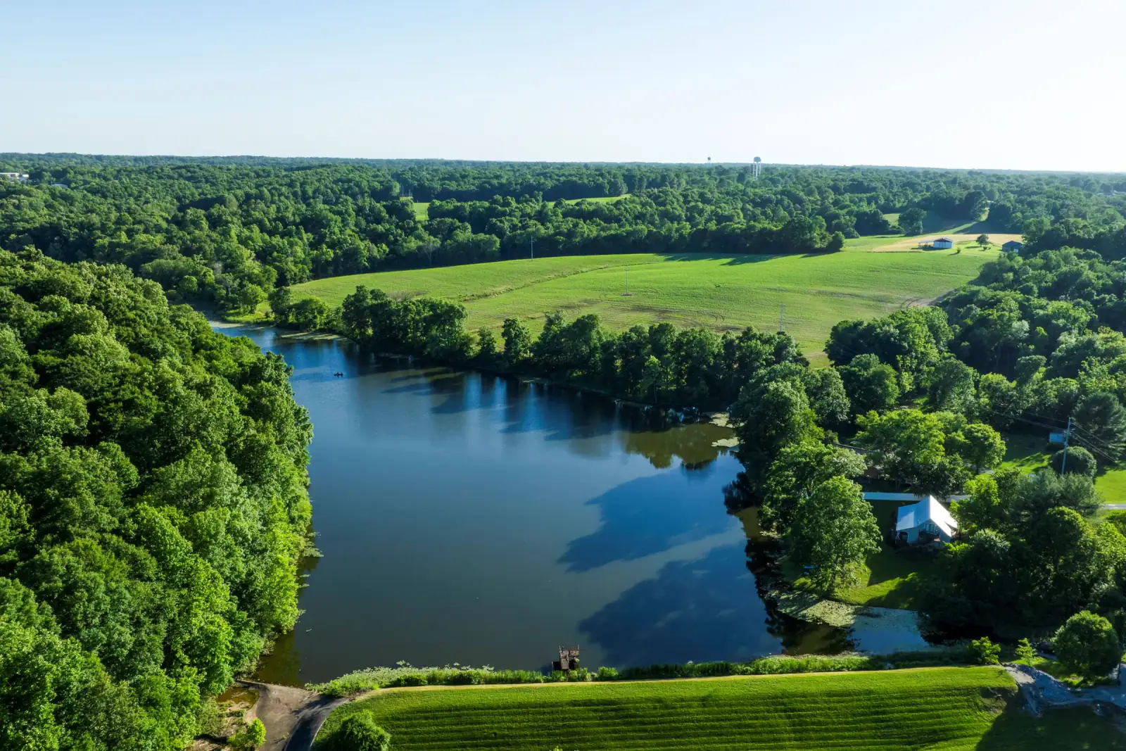 Aerial view of Greenbrier Lake surrounded by green trees and fields in Greenbrier, Tennessee