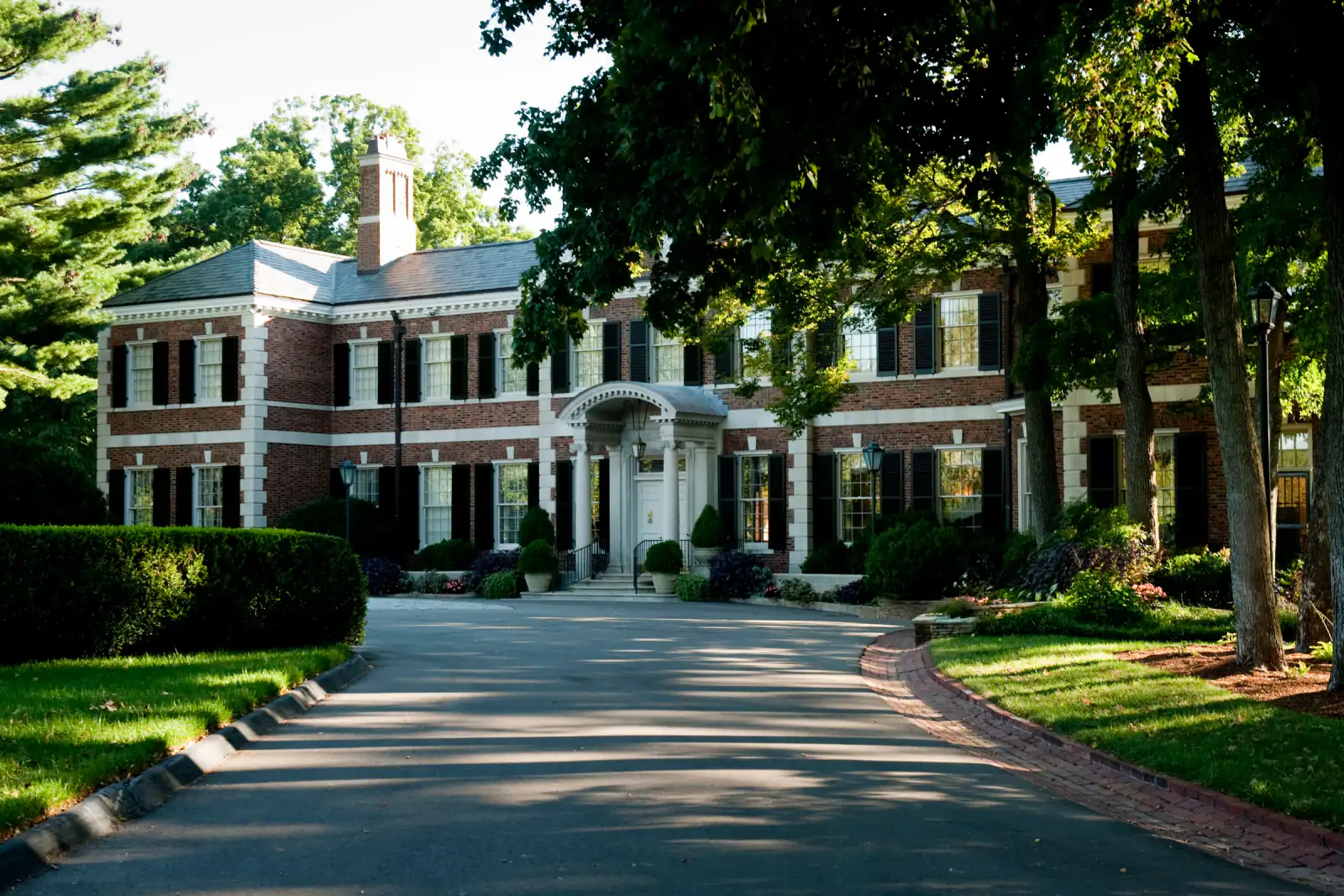 The Tennessee Governor's Residence behind mature trees on Curtiswood Lane, Oak Hill, Tennessee