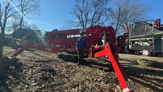 Spider lift and chipper working a tree job